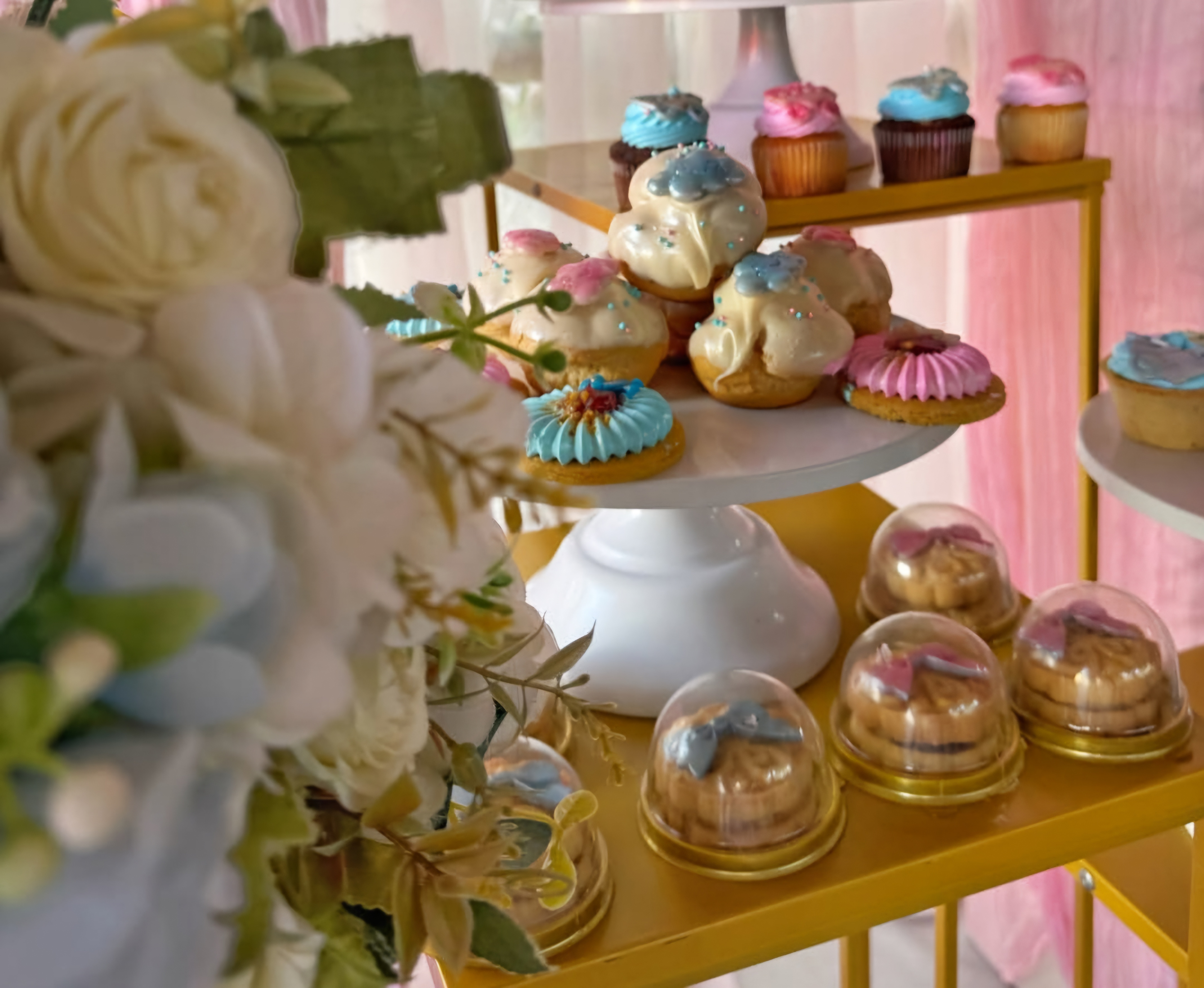 Setup de baby shower celeste y blanco con globos orgánicos y torre de dulces gourmet